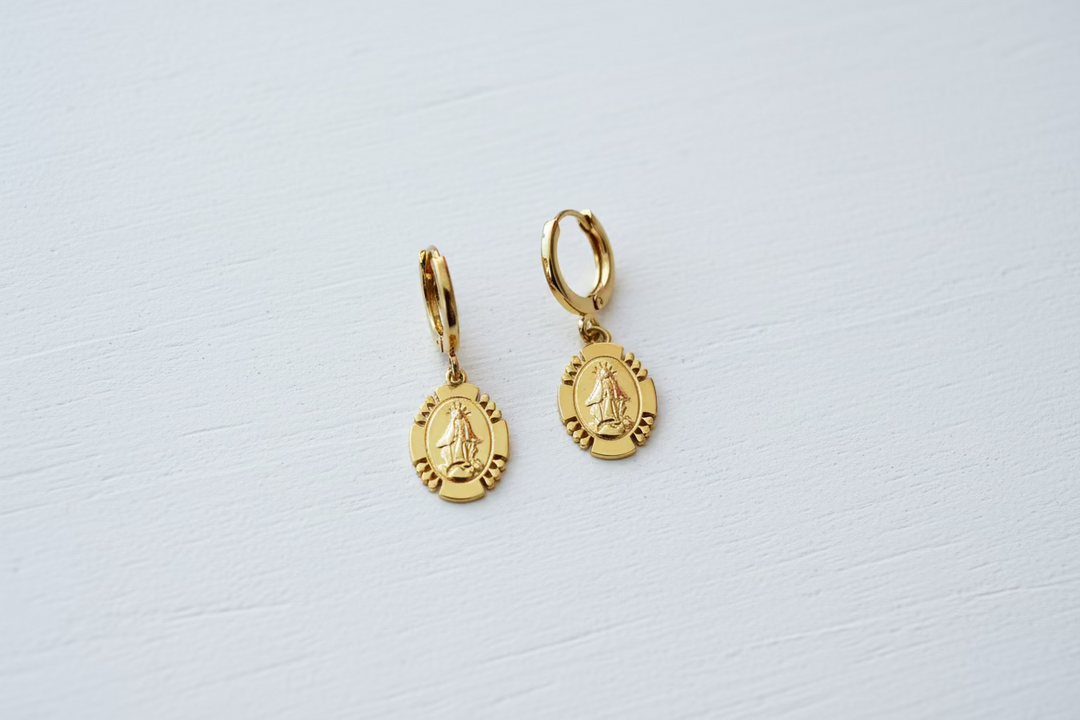 Gold Mary Medallion Huggies Hoop Earrings, Minimalist gold Mary huggie hoops designed for everyday. These 10mm hoops feature petite VM medallion charm 