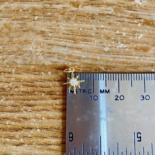 14K Gold Eight Point Star Charm Necklace, our dainty gold star necklace has an eight-point star charm with a cubic zirconia center on a 14k gold-filled chain