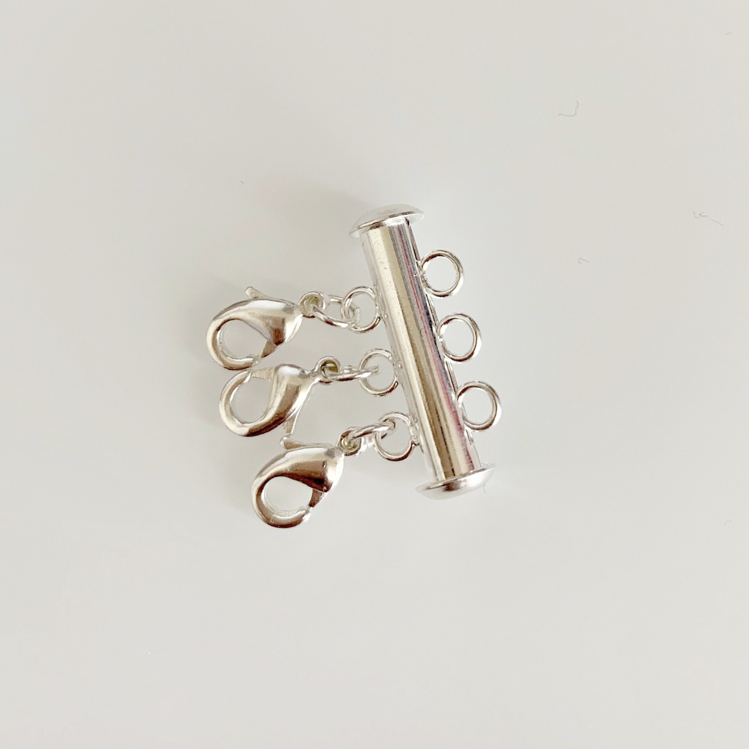 Silver Necklace Spacer Tube For Three Necklaces, our necklace spacer lets you layer three necklaces without tangling. It has three small silver-plated lobster clasps 
