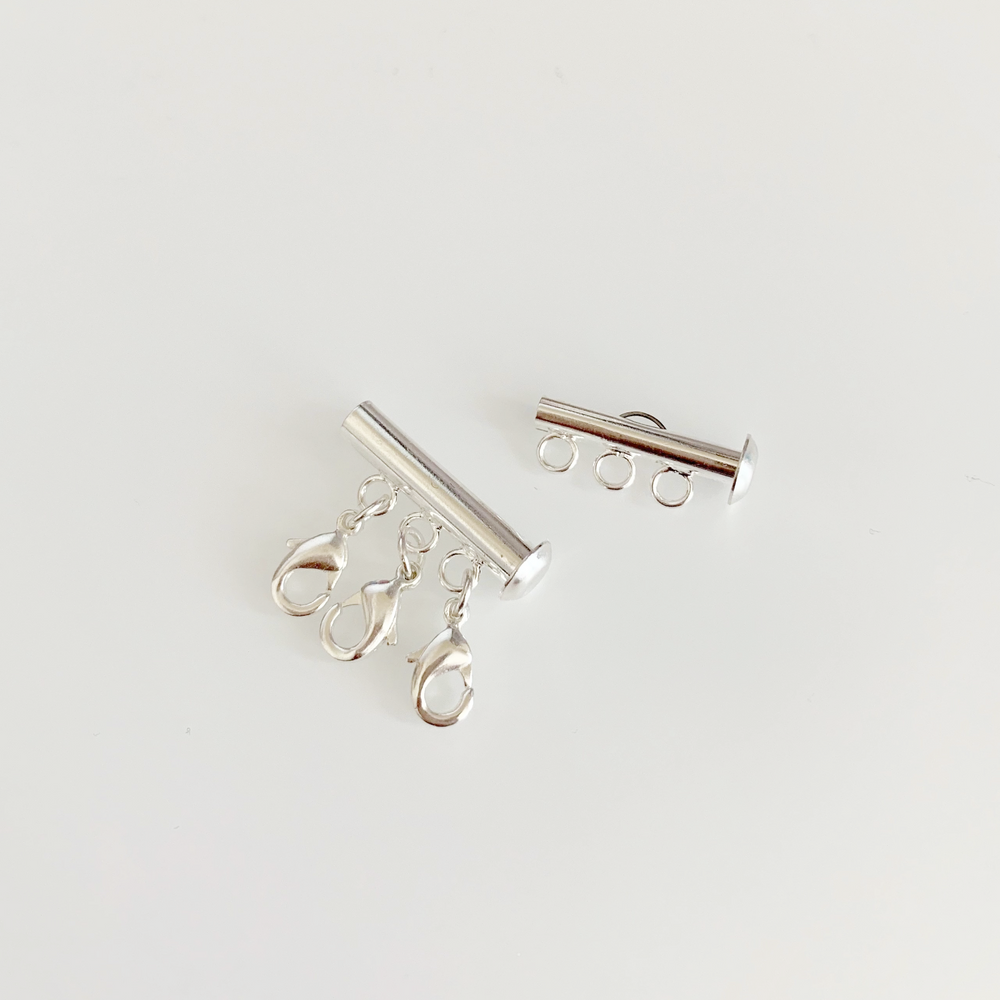 Silver Necklace Spacer Tube For Three Necklaces, our necklace spacer lets you layer three necklaces without tangling. It has three small silver-plated lobster clasps 