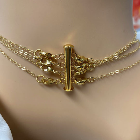 Gold Necklace Spacer Tube For Four Necklaces, our necklace spacer lets you layer up to four necklaces without tangling. It features four small gold-plated lobster clasps 
