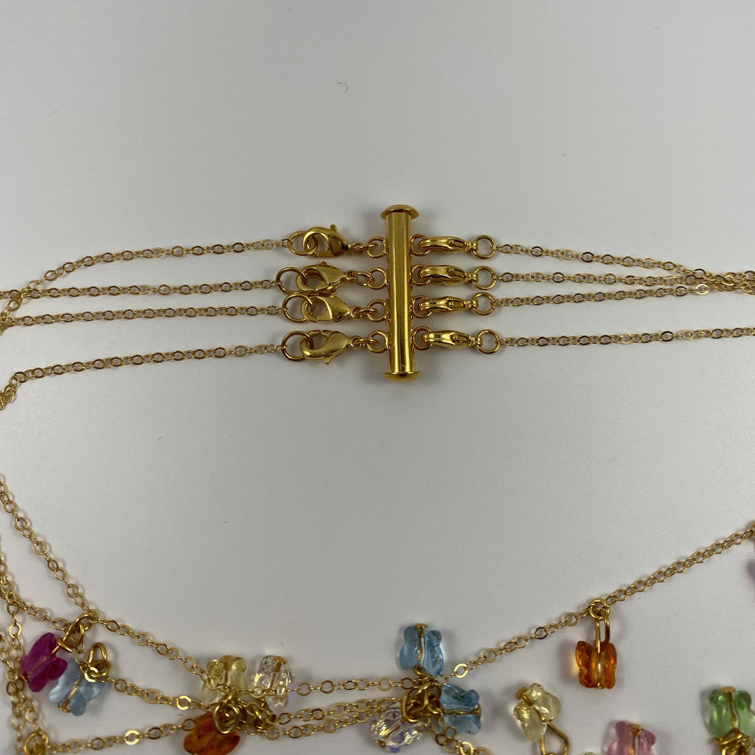 Gold Necklace Spacer Tube For Four Necklaces, our necklace spacer lets you layer up to four necklaces without tangling. It features four small gold-plated lobster clasps 