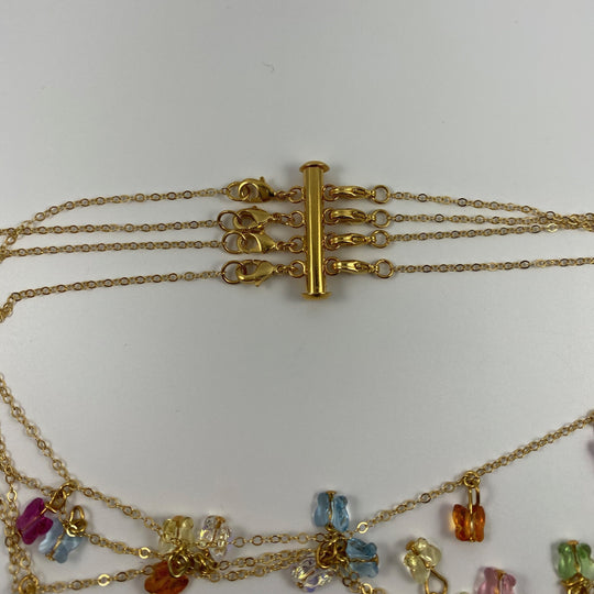 Gold Necklace Spacer Tube For Four Necklaces, our necklace spacer lets you layer up to four necklaces without tangling. It features four small gold-plated lobster clasps 