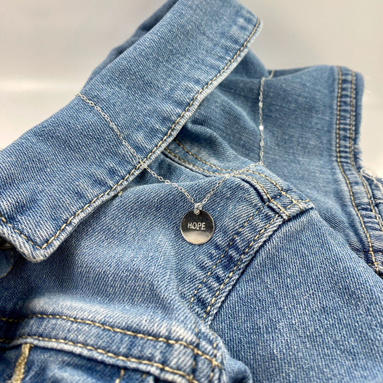 Silver Hand Stamped HOPE Necklace, our delicate gold disk necklace features a hand stamped "HOPE" message in simple script. Its minimalist design and it's delicate chain add a sweet, subtle touch making it a treasure to adore.