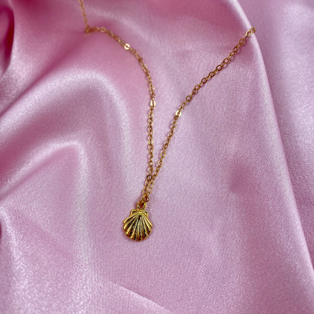 14K Gold Tiny Mermaid Shell Charm Necklace, our tiny mermaid clam shell charm is on 14k gold-filled chain, with a textured front like a clam shell, t