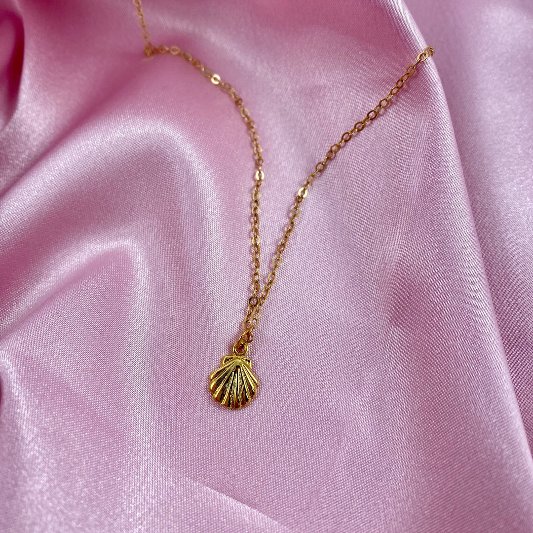 14K Gold Tiny Mermaid Shell Charm Necklace, our tiny mermaid clam shell charm is on 14k gold-filled chain, with a textured front like a clam shell, t