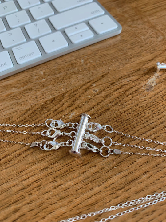 Silver Necklace Spacer Tube For Three Necklaces, our necklace spacer lets you layer three necklaces without tangling. It has three small silver-plated lobster clasps 
