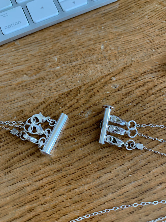 Silver Necklace Spacer Tube For Three Necklaces, our necklace spacer lets you layer three necklaces without tangling. It has three small silver-plated lobster clasps 