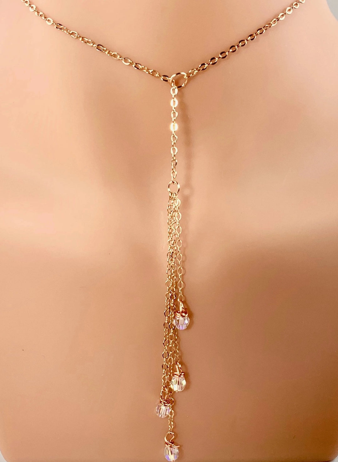 Evening Crystal Sparkle Rose Gold Lariat is our unique design made to be Sweet & Petite is just that. The Rose Gold Lariat chain leads to four dangling chain strands with four sparkling clear crystals to finish the ends. 