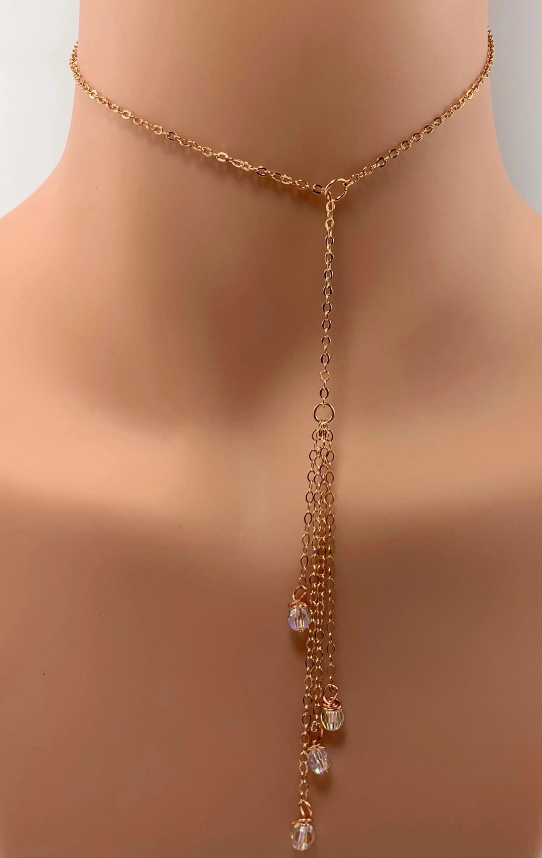 Evening Crystal Sparkle Rose Gold Lariat is our unique design made to be Sweet & Petite is just that. The Rose Gold Lariat chain leads to four dangling chain strands with four sparkling clear crystals to finish the ends. 