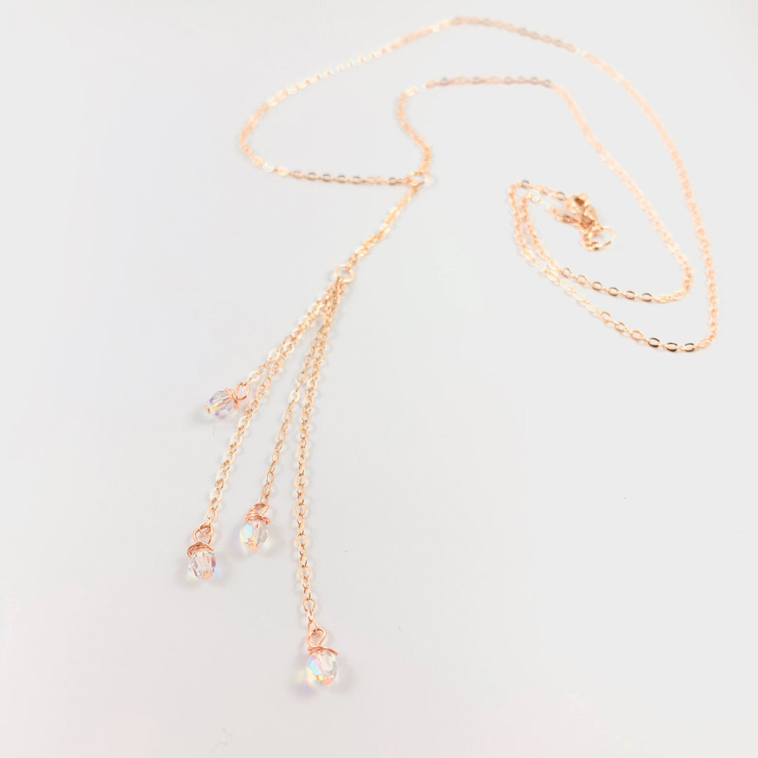 Evening Crystal Sparkle Rose Gold Lariat is our unique design made to be Sweet & Petite is just that. The Rose Gold Lariat chain leads to four dangling chain strands with four sparkling clear crystals to finish the ends. 