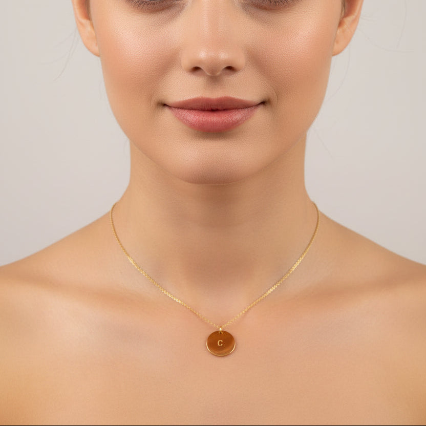 Gold Hand Stamped Initial Necklace, our dainty necklace features a 12mm gold disk hand-stamped with your chosen initial, with a delicate 14K gold-filled chain. Personal and sweet, a treasure to adore.