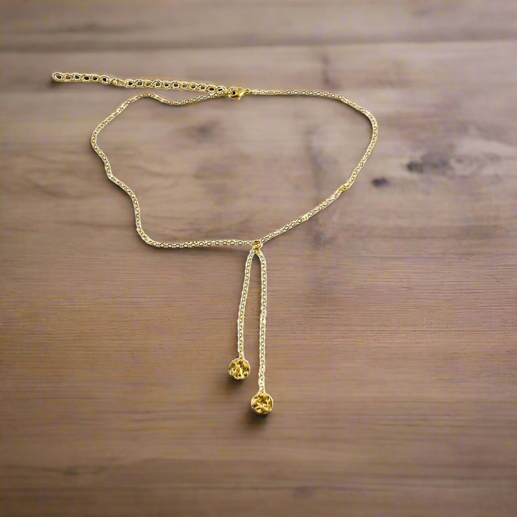 Gold Disk Charm Choker Necklace, has a minimalist vibe to it with two tiny hammered gold disks on 14k gold-filled chain. This unique blend of a faux lariat style and charm offer a intriguing piece of jewelry.