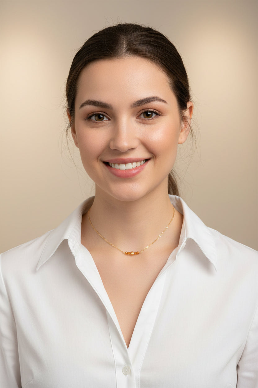 Topaz Orange Crystal Bar Necklace, this necklace has five tiny crystals on a 14k gold-filled chain. Petite and charming, it adds a subtle sparkle.