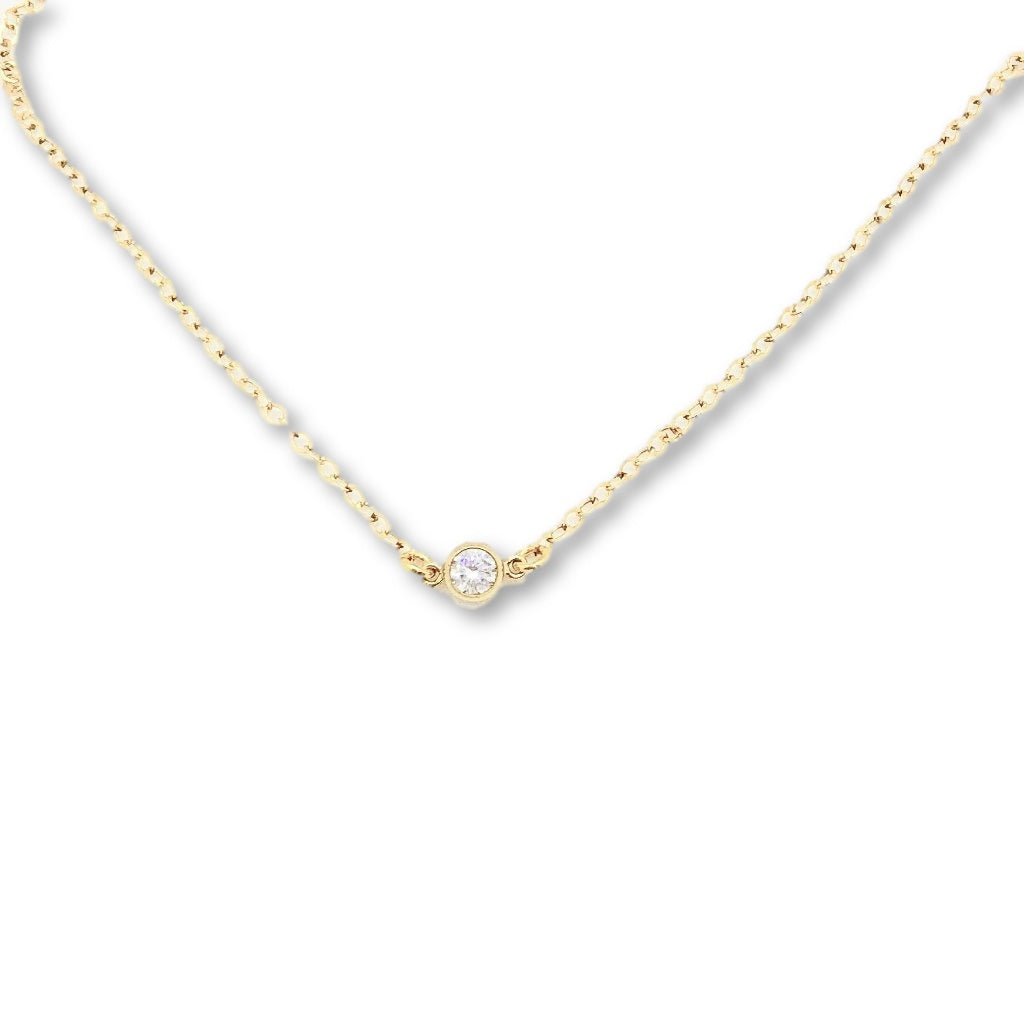 Tiny Cubic Zirconia Solitaire Necklace, this delicate necklace features a tiny 4mm cubic zirconia set on a slim 14K gold filled chain, adding a touch of sweet sparkle to your attire.