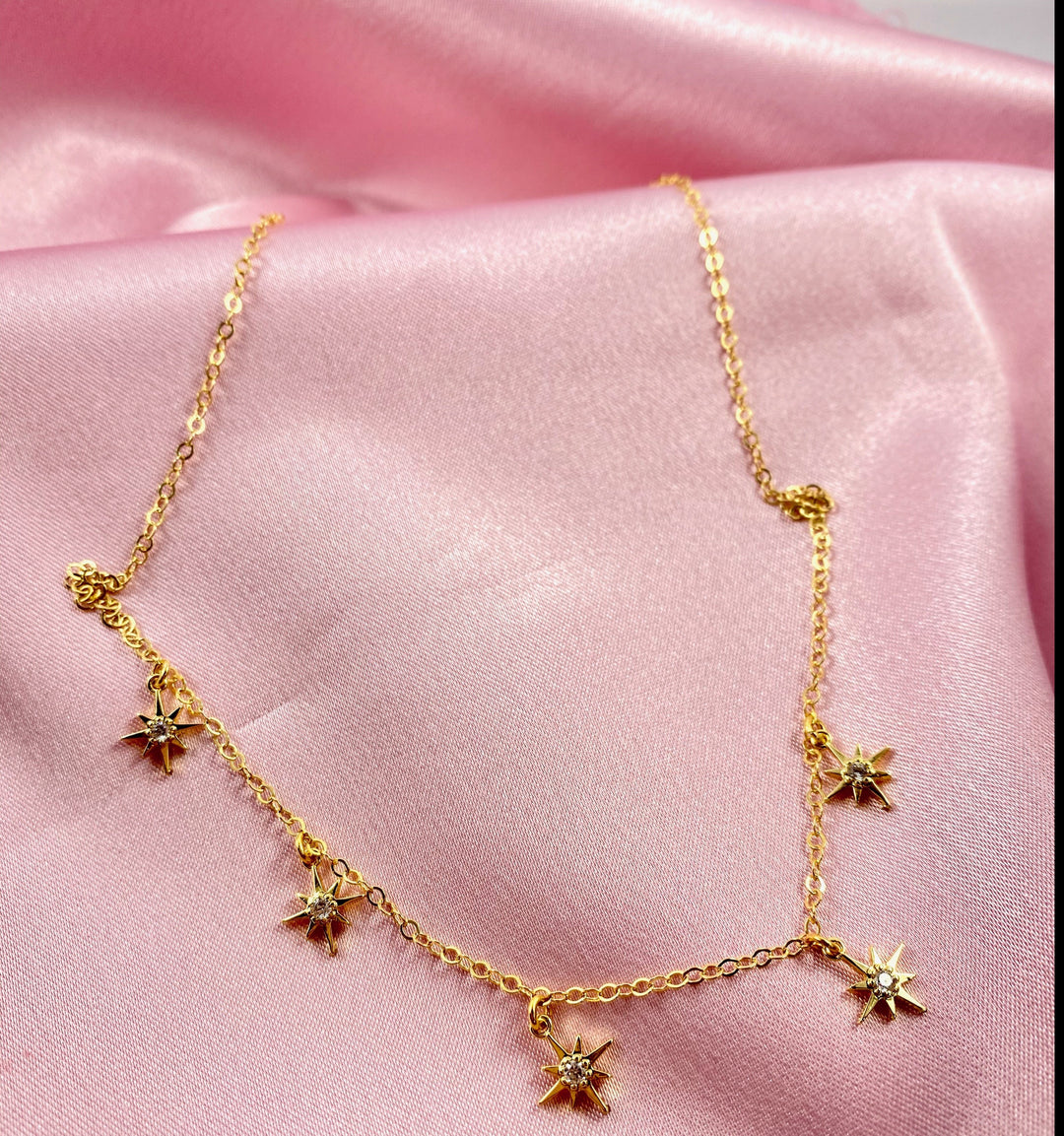 Tiny Star Charm Choker Necklace, hand crafted with tiny gold stars that have a sparkling cubic zirconia crystal center, on 14k gold-filled chain. A unique blend of a sweet & petite jewelry treasure.