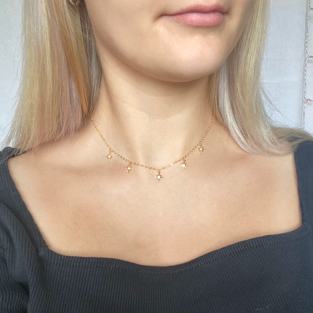 Tiny Star Charm Choker Necklace, hand crafted with tiny gold stars that have a sparkling cubic zirconia crystal center, on 14k gold-filled chain. A unique blend of a sweet & petite jewelry treasure.