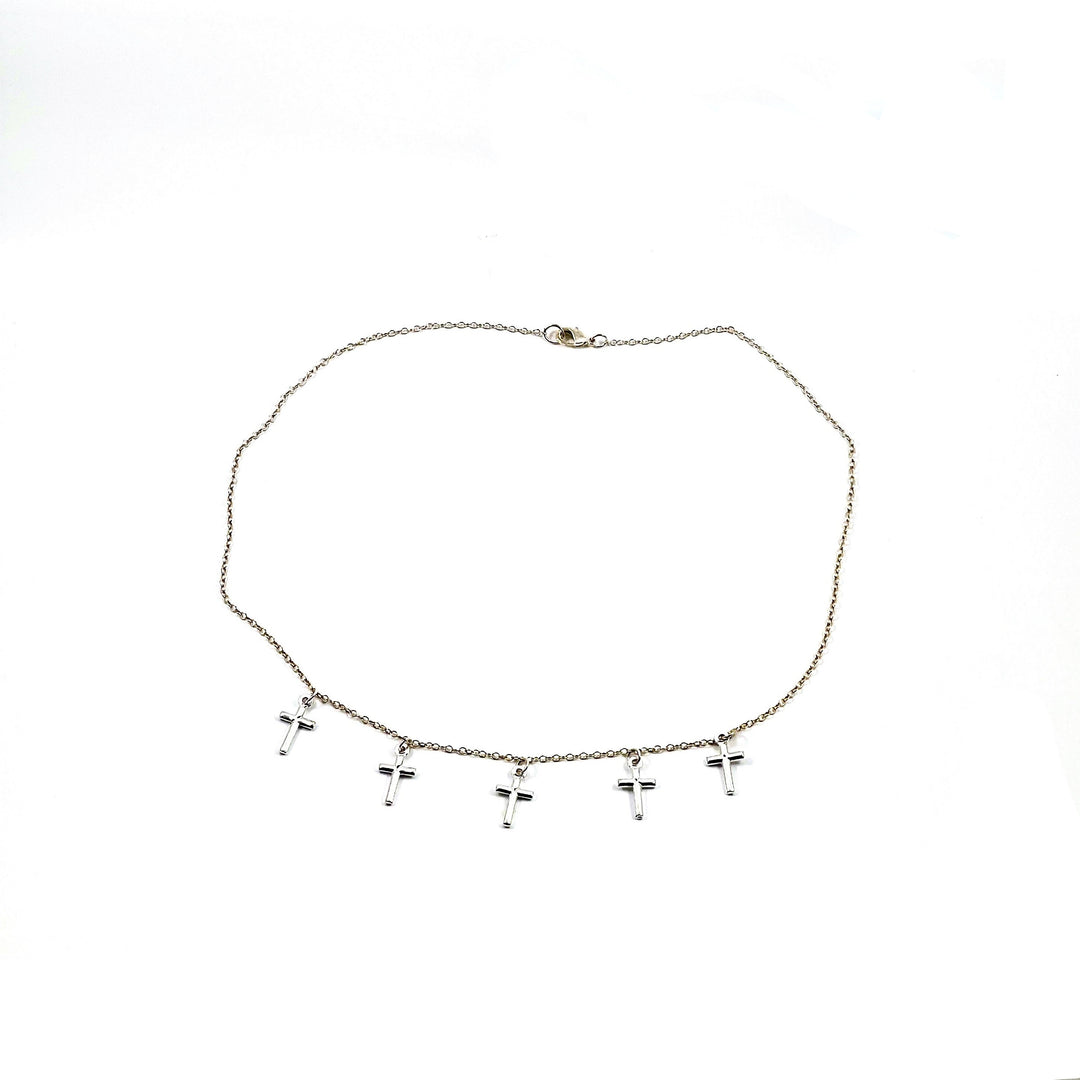 Silver Cross Choker Chain Necklace, made with sterling silver, our Silver Cross Choker Chain Necklace has a subtle dainty touch with tiny silver crosses, making it a unique blend of charm and grace.