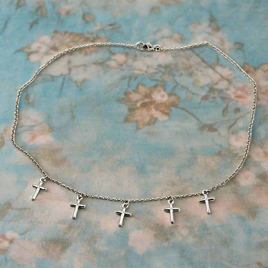 Silver Cross Choker Chain Necklace, made with sterling silver, our Silver Cross Choker Chain Necklace has a subtle dainty touch with tiny silver crosses, making it a unique blend of charm and grace.
