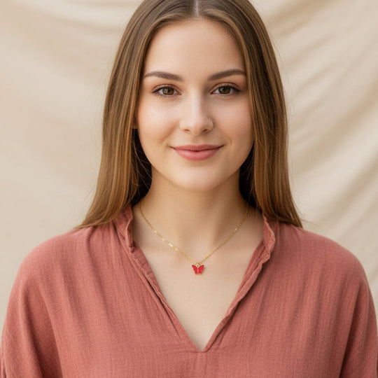 Ruby Red Pearl Butterfly Necklace, is perfect for adding a petite, minimalist charm to any look. Lightweight and eye-catching, the 14K gold filled chain 