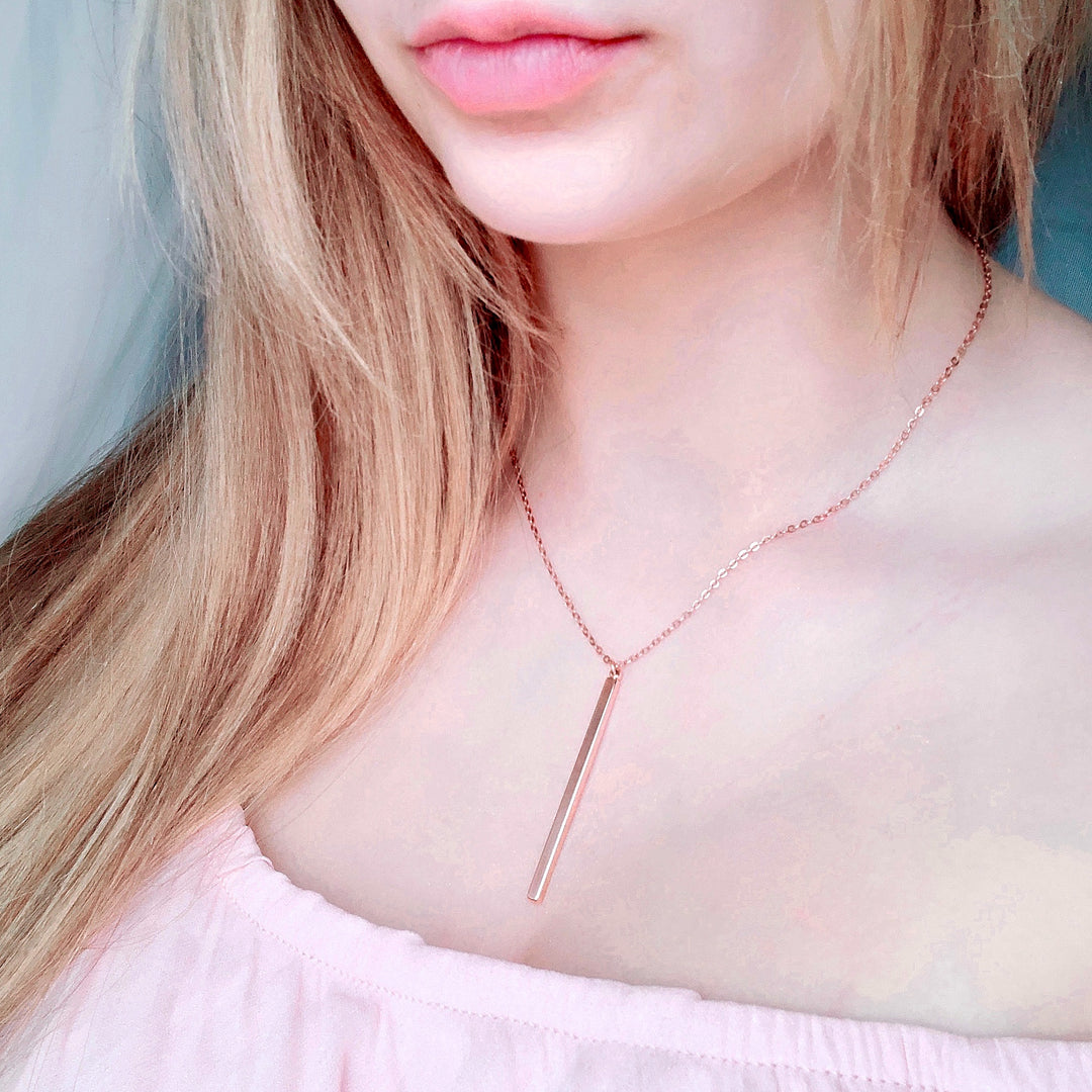 Rose Gold Vertical Bar Necklace, A simple slim rose gold vertical bar hangs from delicate rose gold chain, creating a minimalist necklace design, boho chic piece of jewelry.