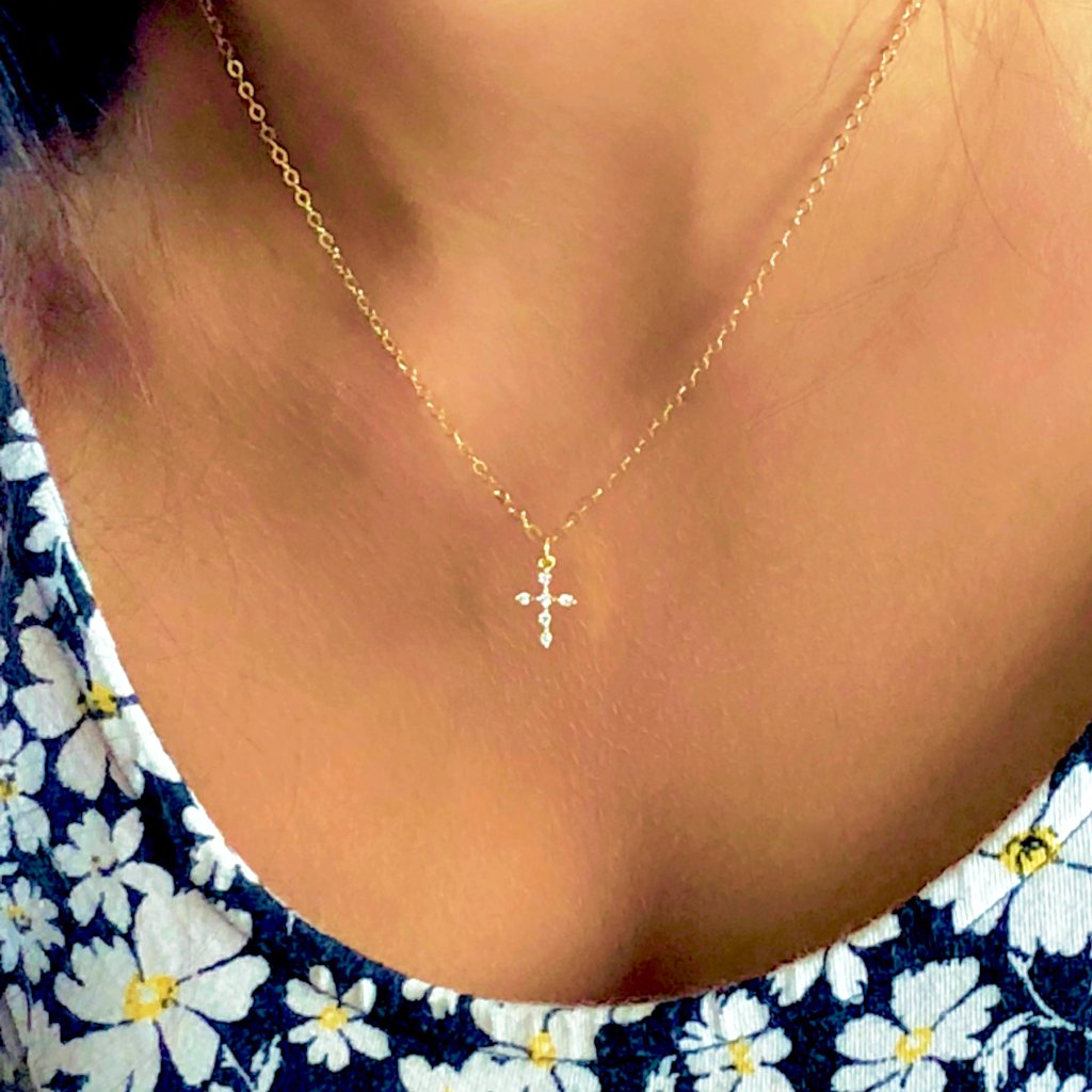 14K Gold Cubic Zirconia Cross Charm Necklace, our delicate 14k gold necklace features a small cubic zirconia crystal cross charm on a 14k gold-filled chain