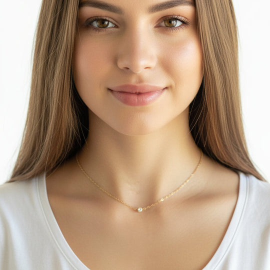 Tiny Cubic Zirconia Solitaire Necklace, this delicate necklace features a tiny 4mm cubic zirconia set on a slim 14K gold filled chain, adding a touch of sweet sparkle to your attire.