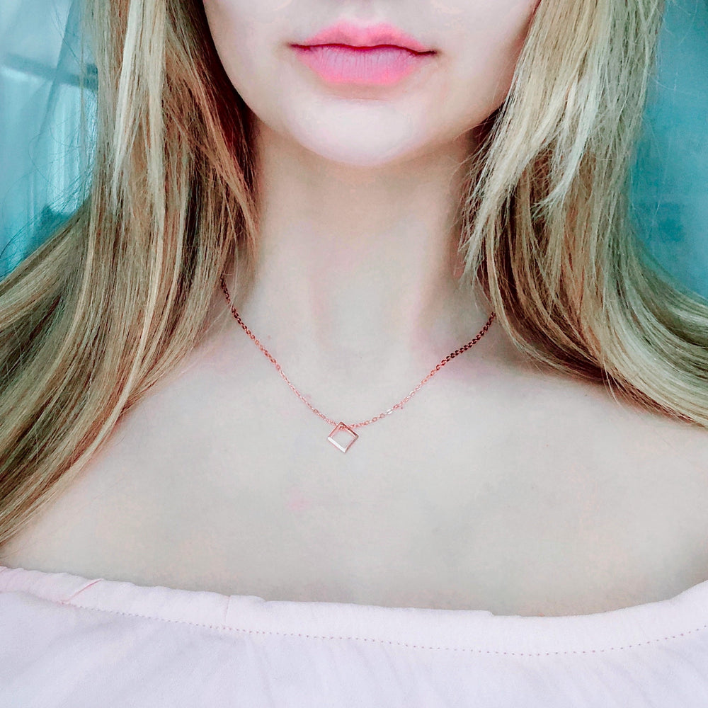 Rose Gold Open Square Charm Necklace, a minimalist charm necklace with a tiny rose gold square on rose gold chain offers a unique perspective on jewelry,