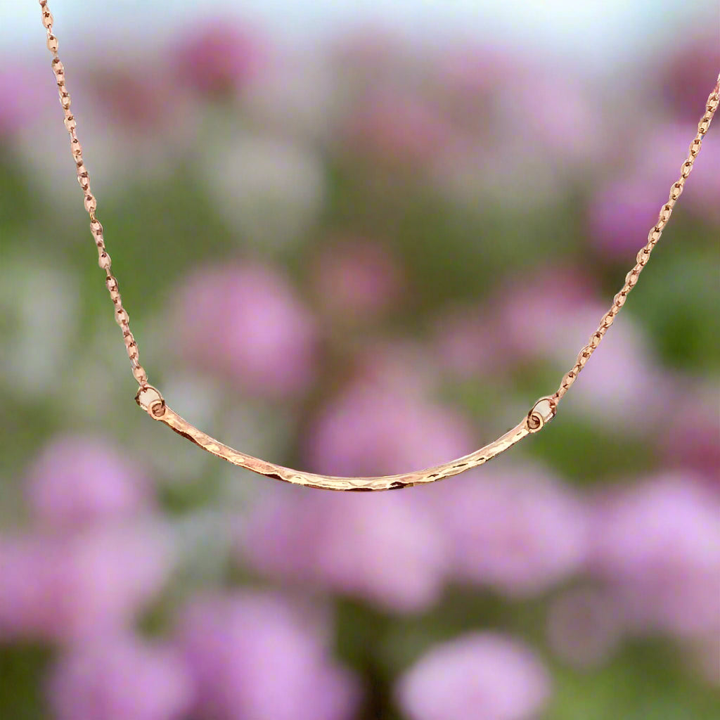 Rose Gold Curved Skinny Bar Necklace, a unique minimalist charm, it's curved surface has a hammered texture and just the right length for a dainty modern appeal.