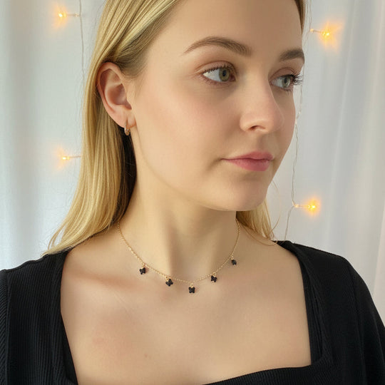 Black Crystal Butterfly Necklace worn by a model, showcasing handcrafted black crystal butterflies on a delicate gold-fill chain.