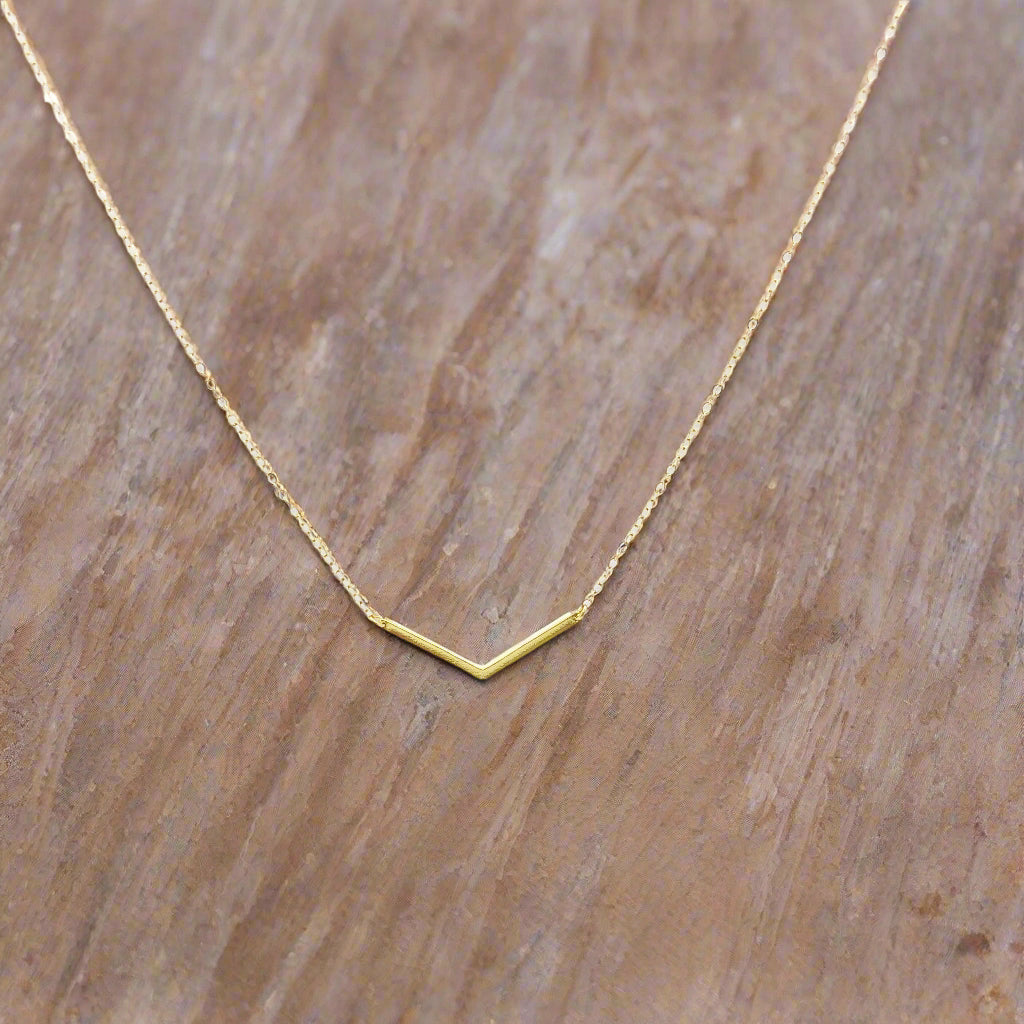14K Gold Chevron V Bar Charm Necklace, our petite chevron V bar charm on 14k gold-filled chain equals a sweet minimalist charm necklace for everyday wear.
