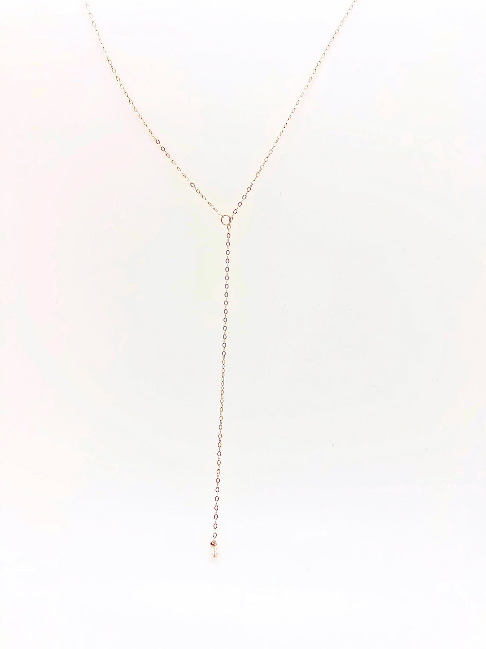 Rose Gold Crystal Lariat Charm Necklace, a tiny clear crystal hand wire-wrapped on rose gold chain completes this lariat with a petite circle charm for the slide of the lariat, 