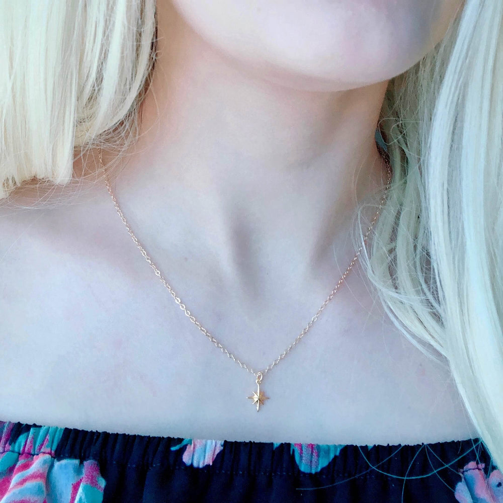 14K Gold North Star Charm Necklace, our eight-point North Star Charm Necklace has a tiny gold 8 point star charm on 14k gold-filled chain, it's a charming 