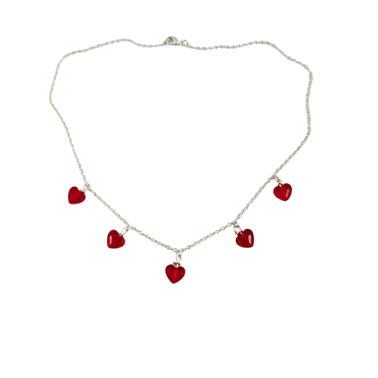 This Ruby Red Crystal Heart Necklace is irresistibly sweet and petite, featuring five tiny heart-shaped crystals wire wrapped on a sterling silver chain 