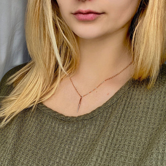 Rose Gold Needle Spike Charm Necklace, our dainty necklace features a minimalist rose gold needle spike charm suspended from a slender rose gold chain