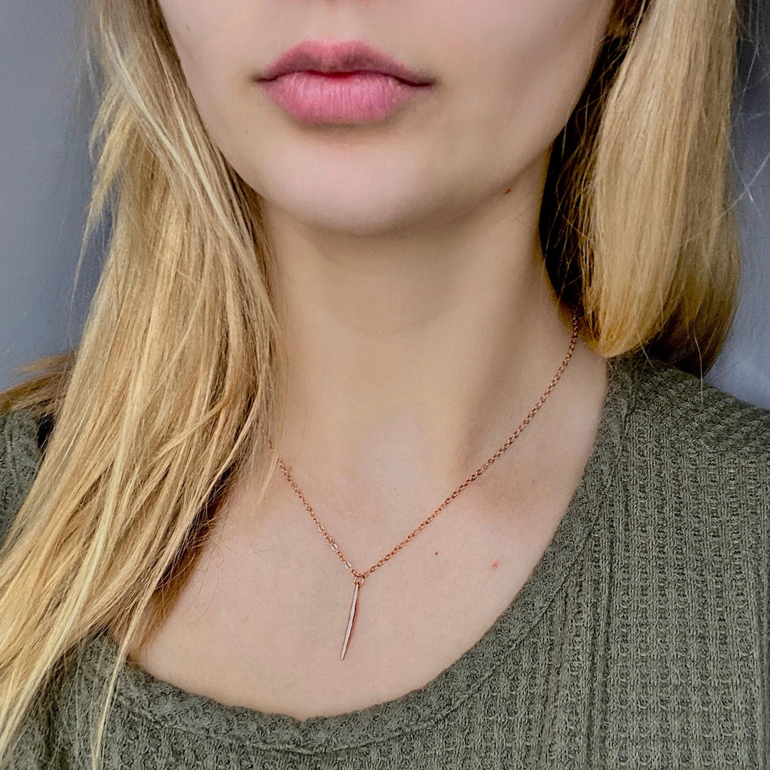 Rose Gold Needle Spike Charm Necklace, our dainty necklace features a minimalist rose gold needle spike charm suspended from a slender rose gold chain