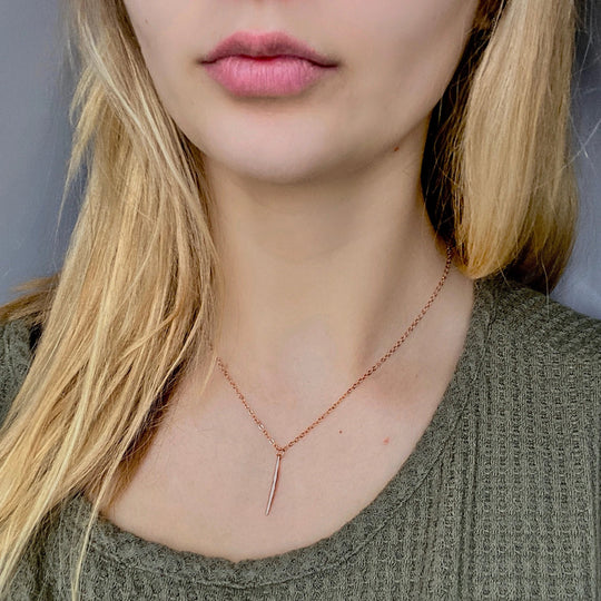 Rose Gold Needle Spike Charm Necklace, our dainty necklace features a minimalist rose gold needle spike charm suspended from a slender rose gold chain
